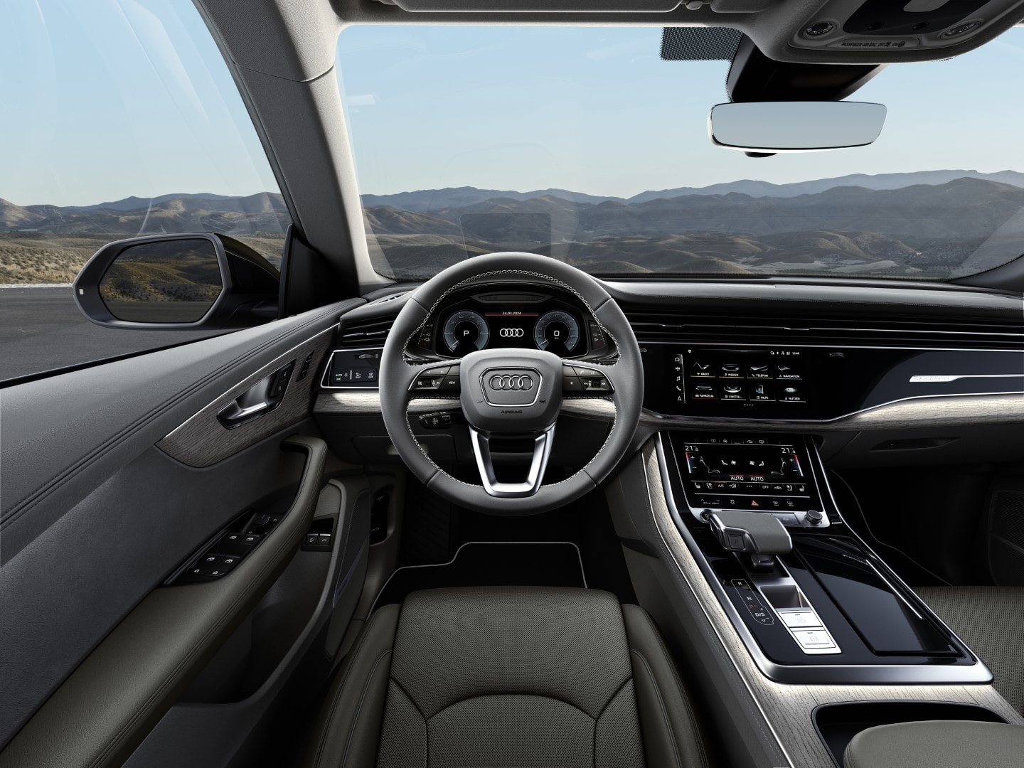Enfoque en el volante y panel de instrumentación del Audi Q8 híbrido.