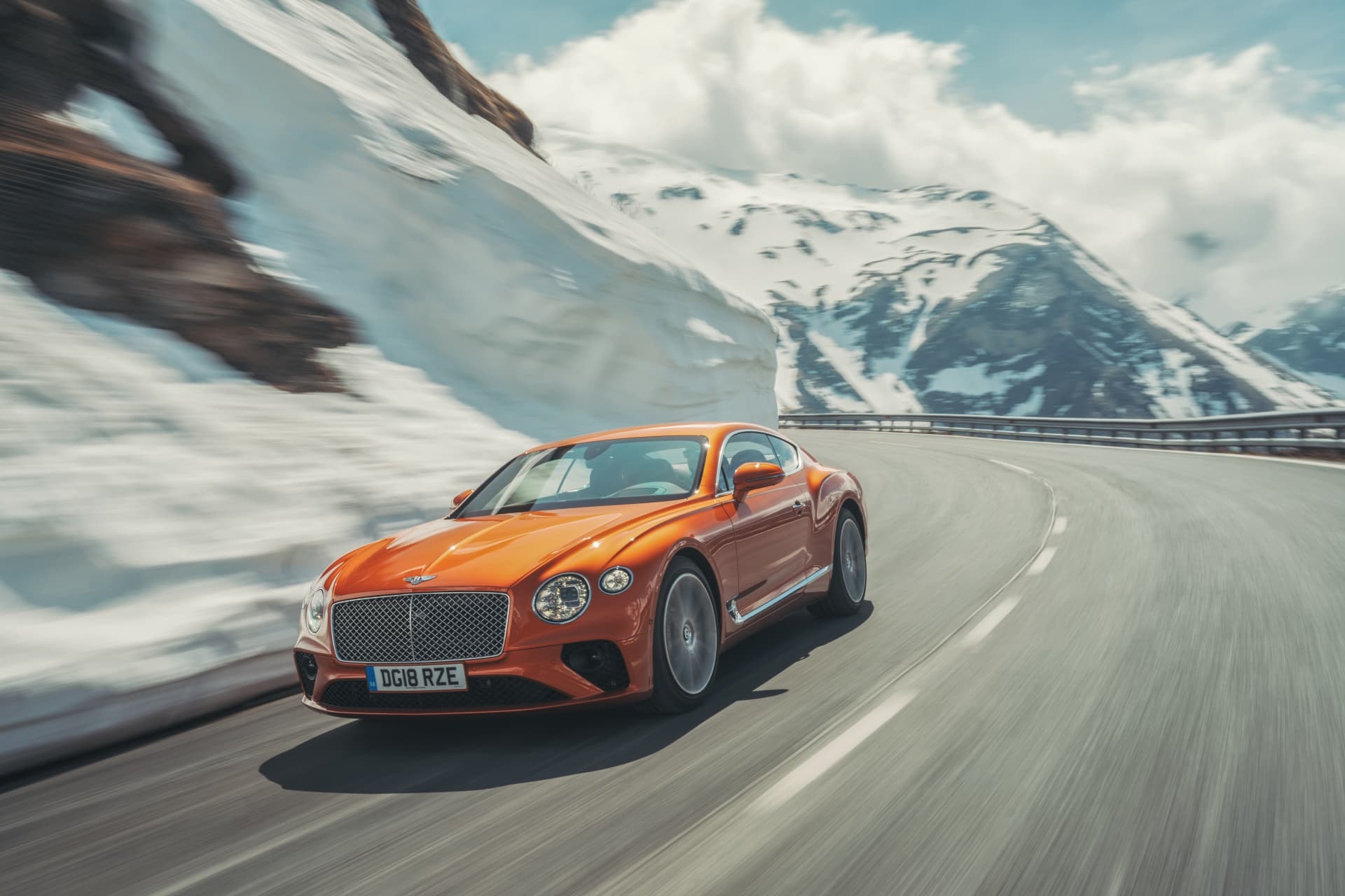 Imagen del Bentley Continental GT en acción, mostrando su diseño desde un ángulo delantero lateral.