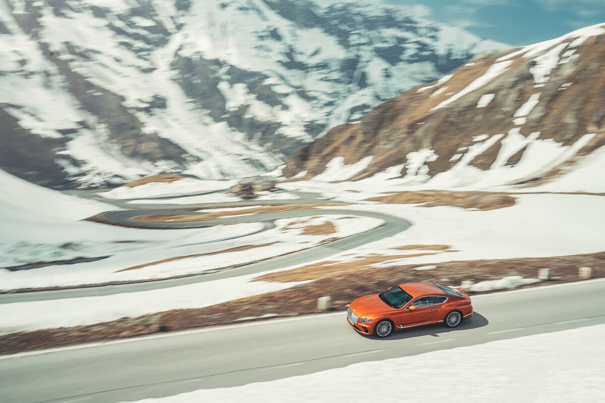 El Bentley Continental GT exhibiendo su silueta lateral mientras recorre curvas montañosas. El Bentley Continental GT exhibiendo su silueta lateral mientras recorre curvas montañosas.