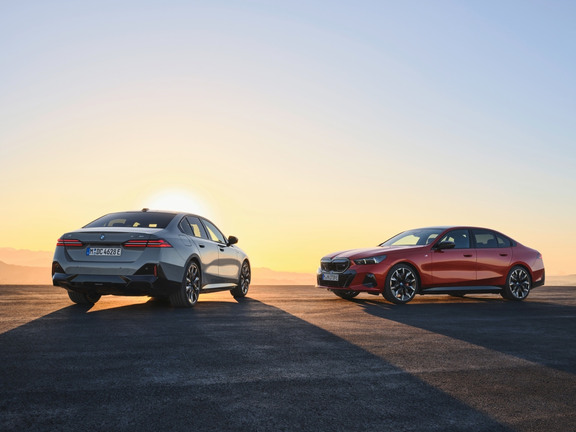 Dos Serie 5 en contraluz al atardecer, destacando silueta.