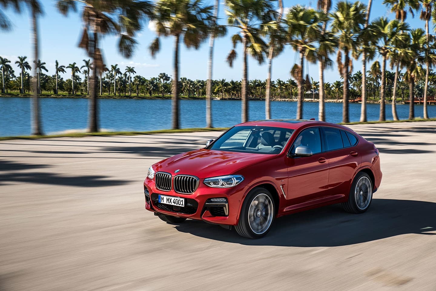 Toma en movimiento del BMW X4, con vista delantera y lateral.