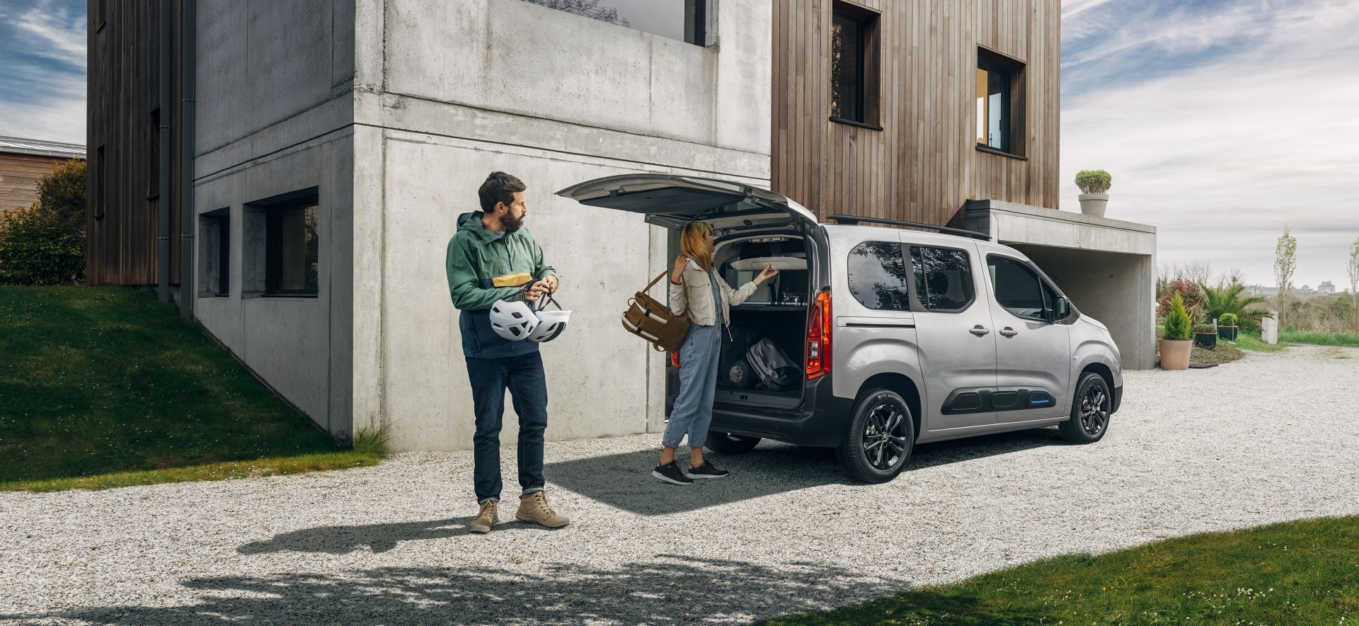 Citroën Berlingo mostrando su funcionalidad y espacio de carga con hombre apoyado.