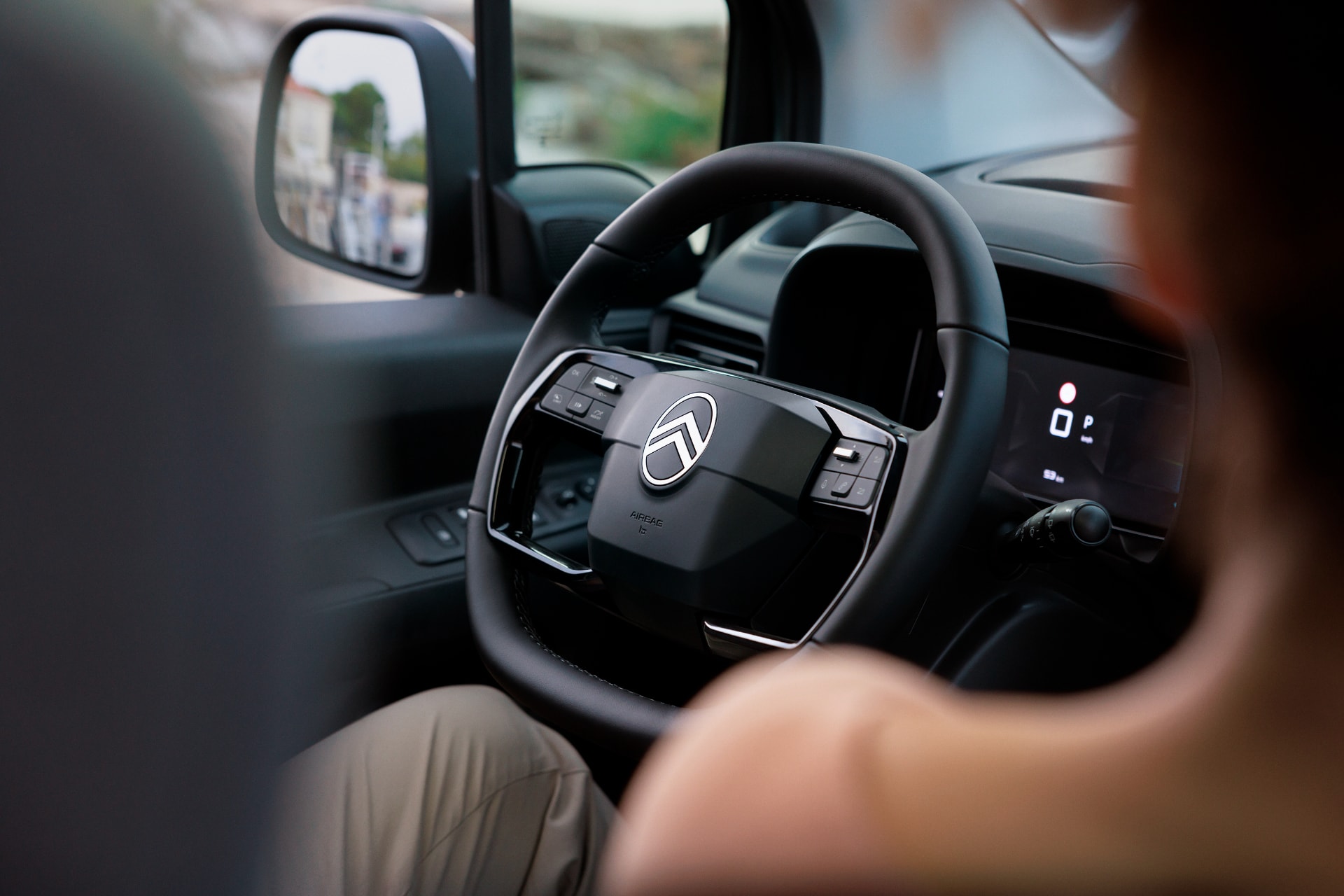 Perspectiva del conductor del Citroën ë-Berlingo, mostrando parte del volante y el tablero.