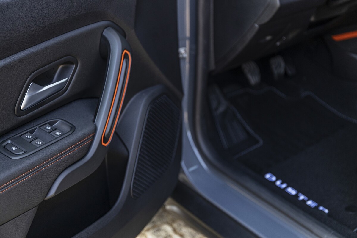 Vista del detalle de la puerta del conductor con decoración naranja en el Dacia Duster. Vista del detalle de la puerta del conductor con decoración naranja en el Dacia Duster.