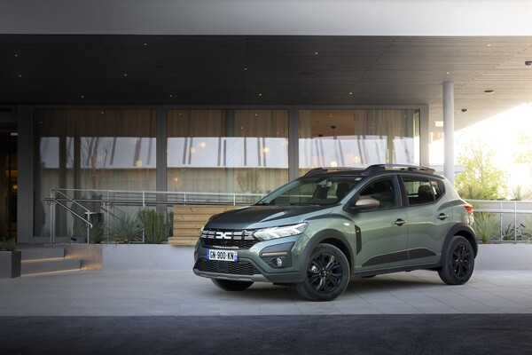 Imagen del Dacia Sandero Stepway frente a arquitectura contemporánea, mostrando su lado delantero y lateral.