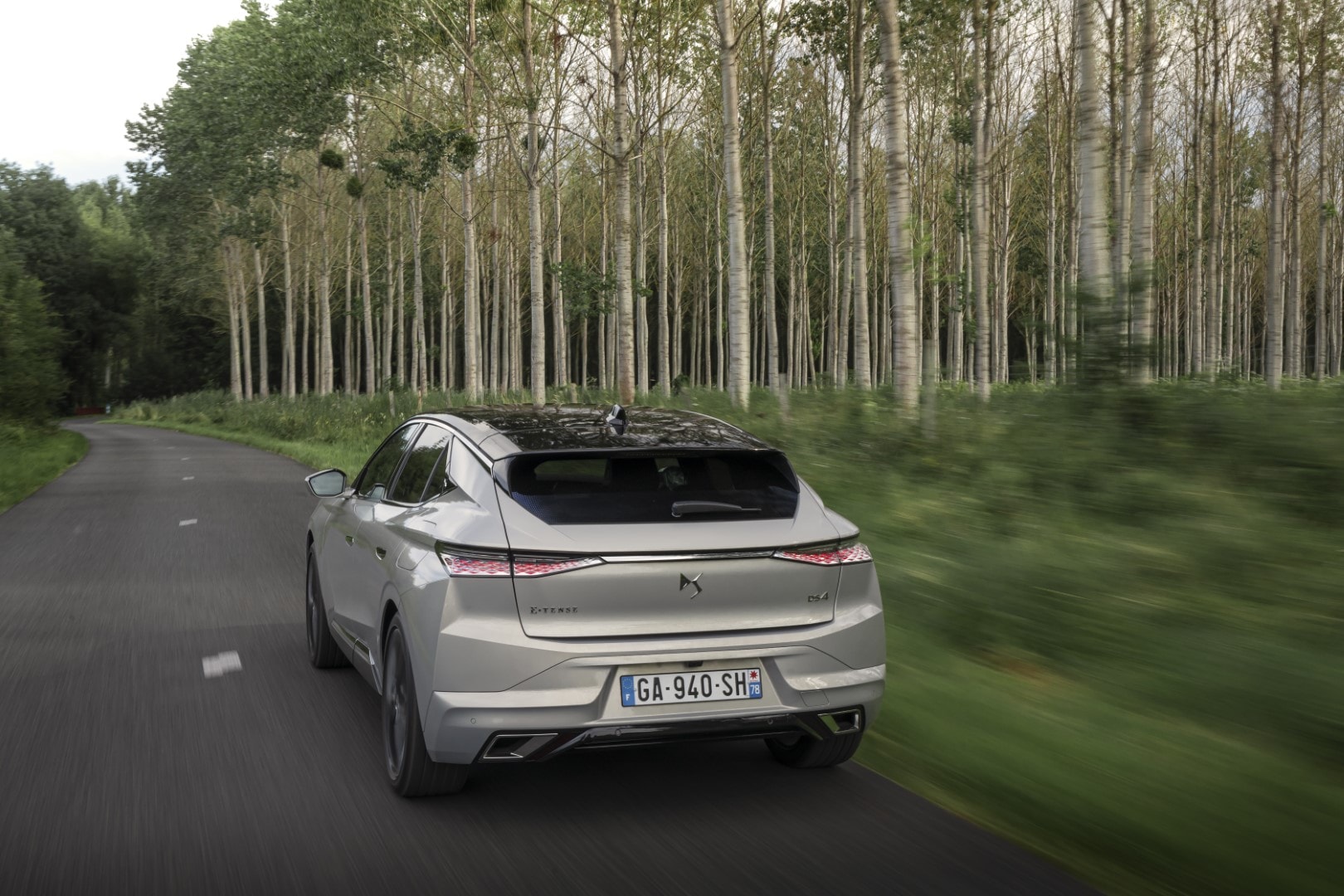 Perfil trasero del vehículo en movimiento mostrando dinamismo.