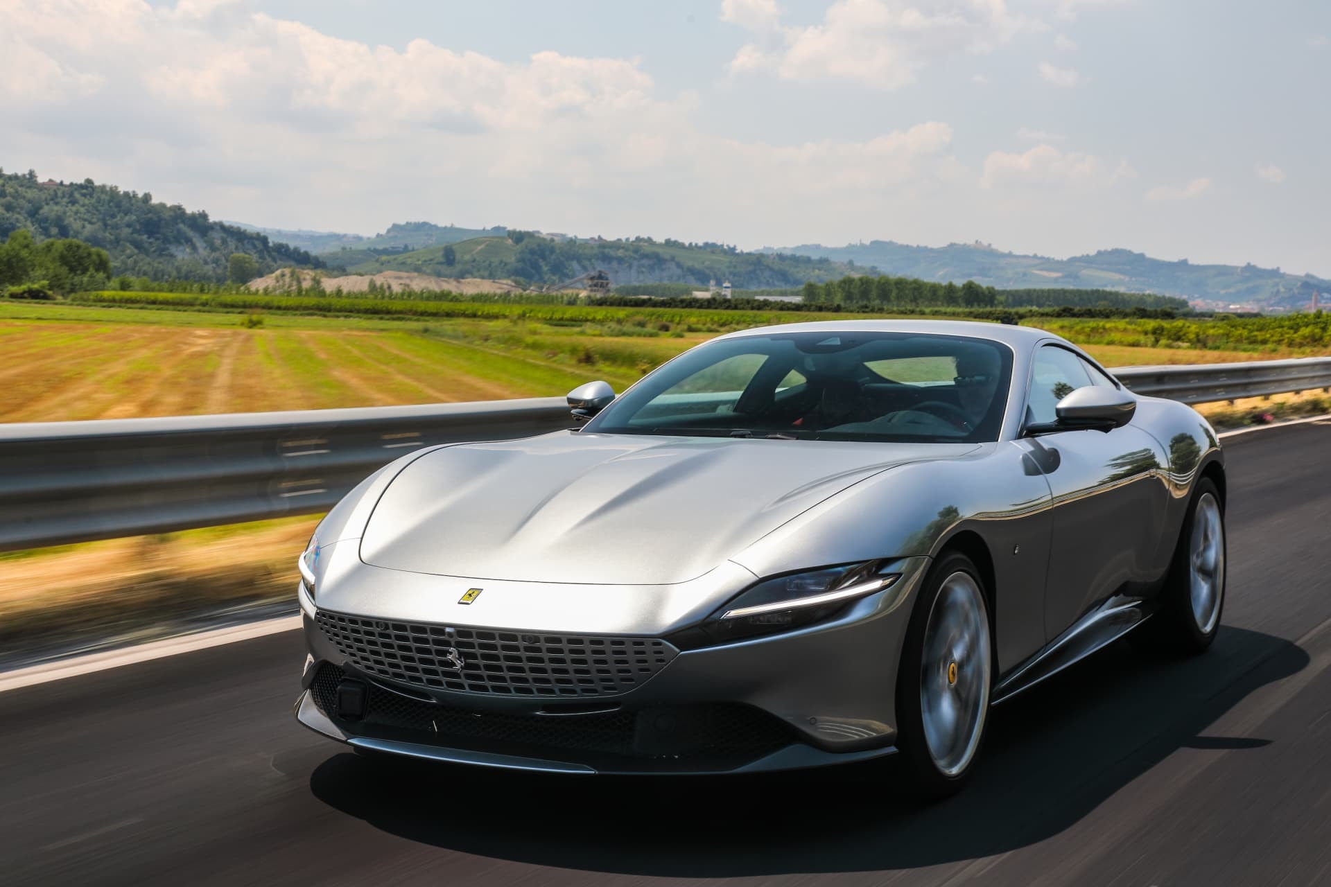 Ferrari Roma capturado de frente y en velocidad, exaltando su línea y potencia.