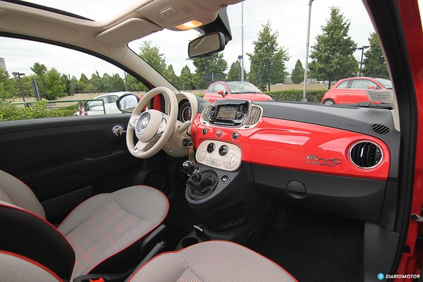 Tablero interior del Fiat 500 con acentos en rojo, volante y panel central visible. Tablero interior del Fiat 500 con acentos en rojo, volante y panel central visible.