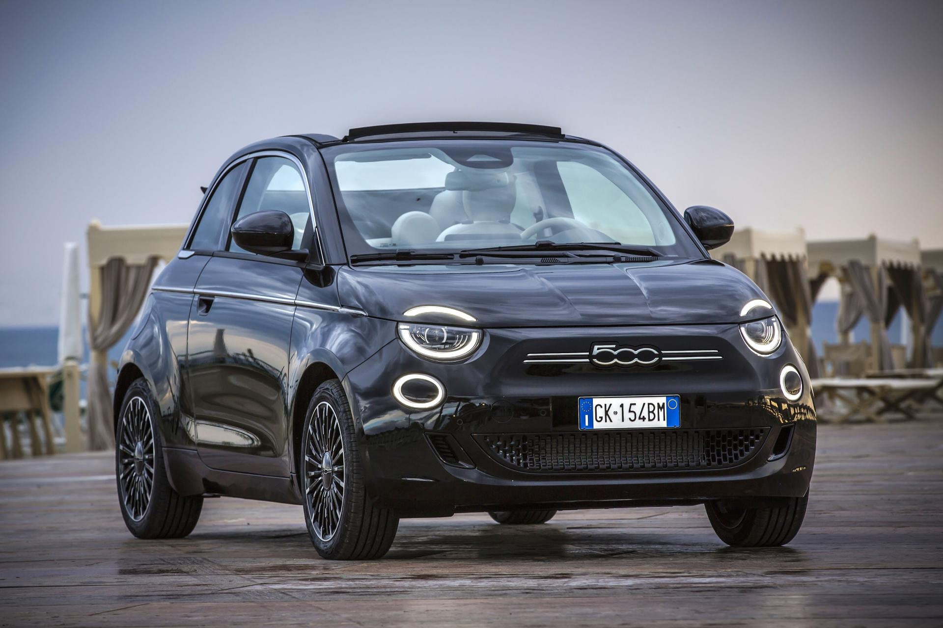Vista frontal del Fiat 500C, imagen que impone su diseño en un entorno marítimo.