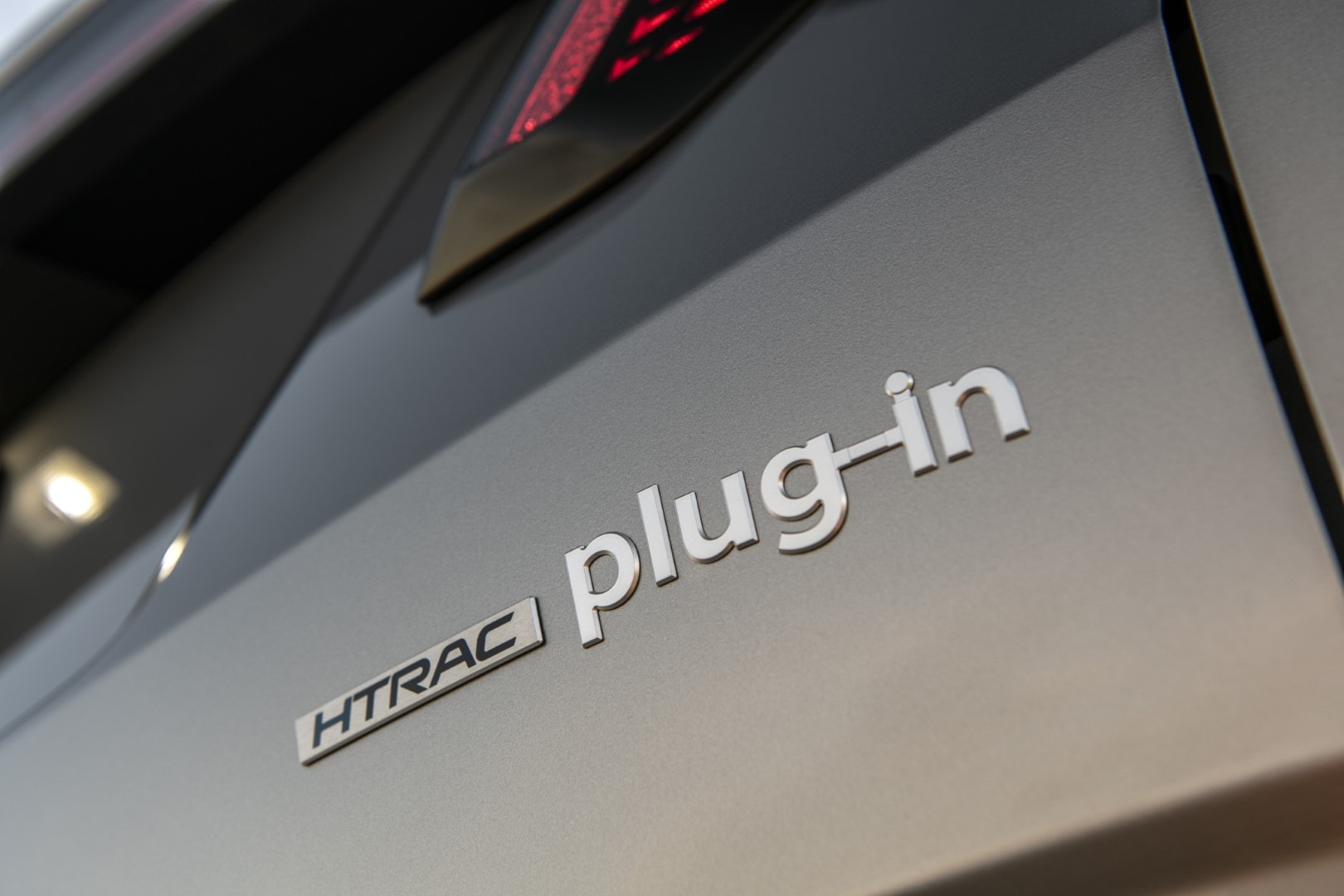 Detalle de la etiqueta HTRAC plug-in, indicativo de tecnología híbrida enchufable.