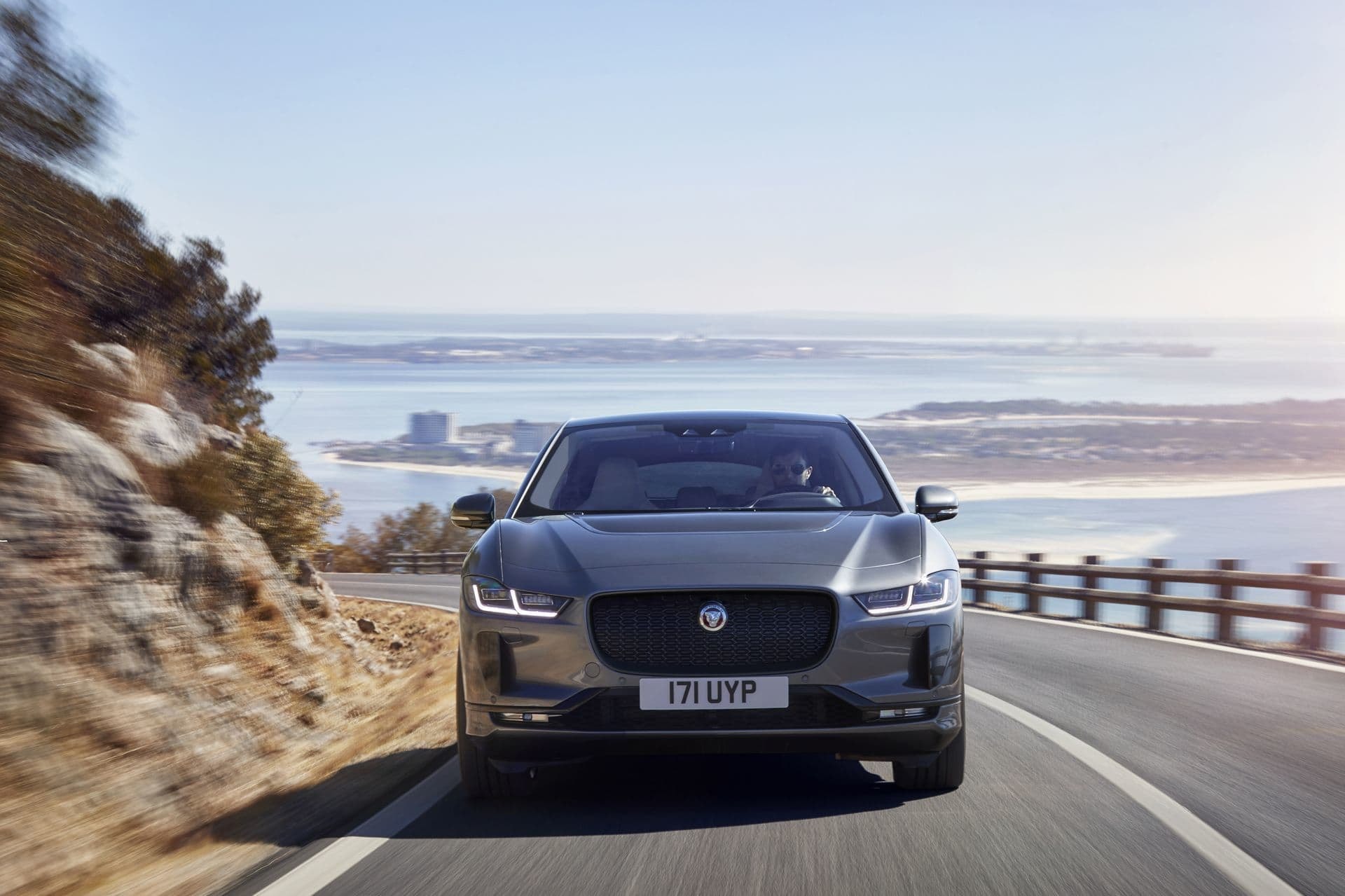 Vista frontal del Jaguar I-Pace eléctrico en carretera, destacando la parrilla y el emblema.