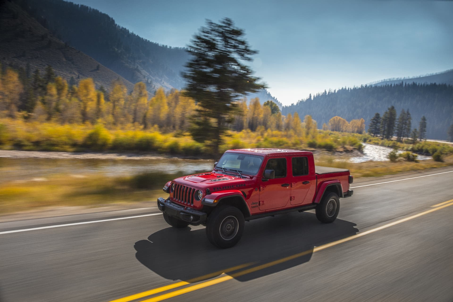 Perfil del Jeep Gladiator recorriendo paisaje fluvial.
