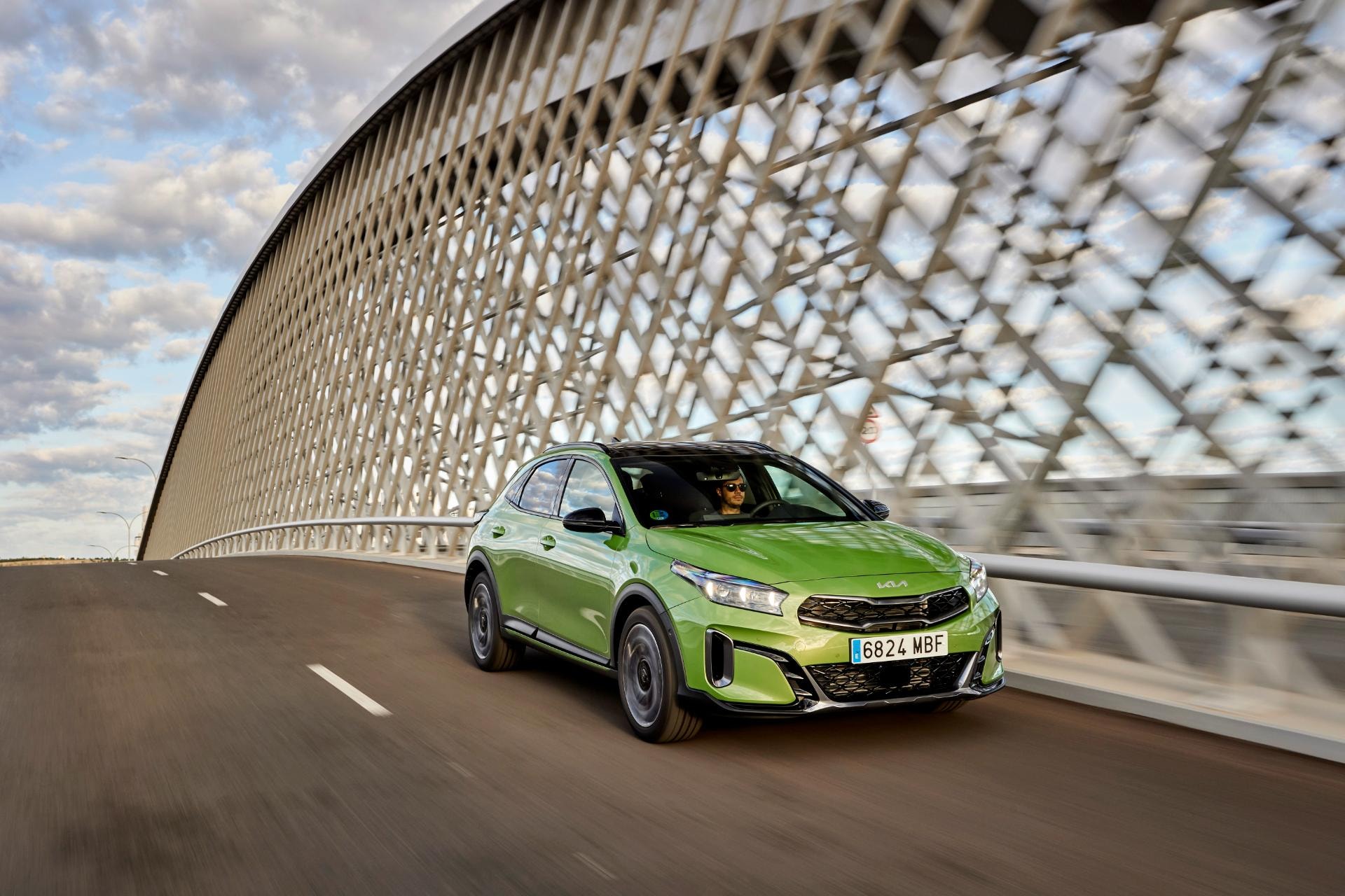 El Kia Xceed Híbrido sobre un puente, combinando diseño y entorno arquitectónico.