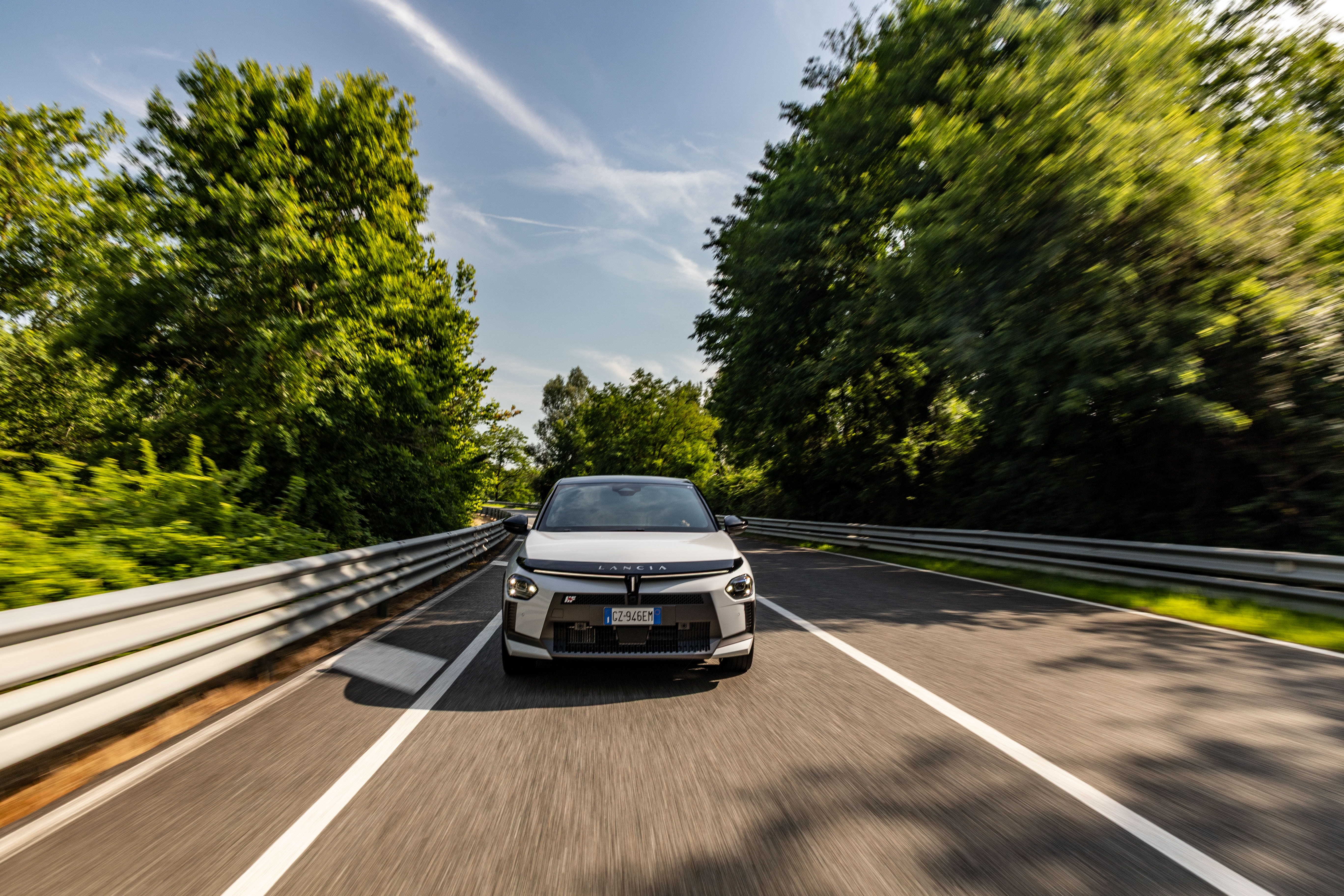 Vista lateral del Lancia Ypsilon en movimiento, destacando su elegancia y diseño moderno.