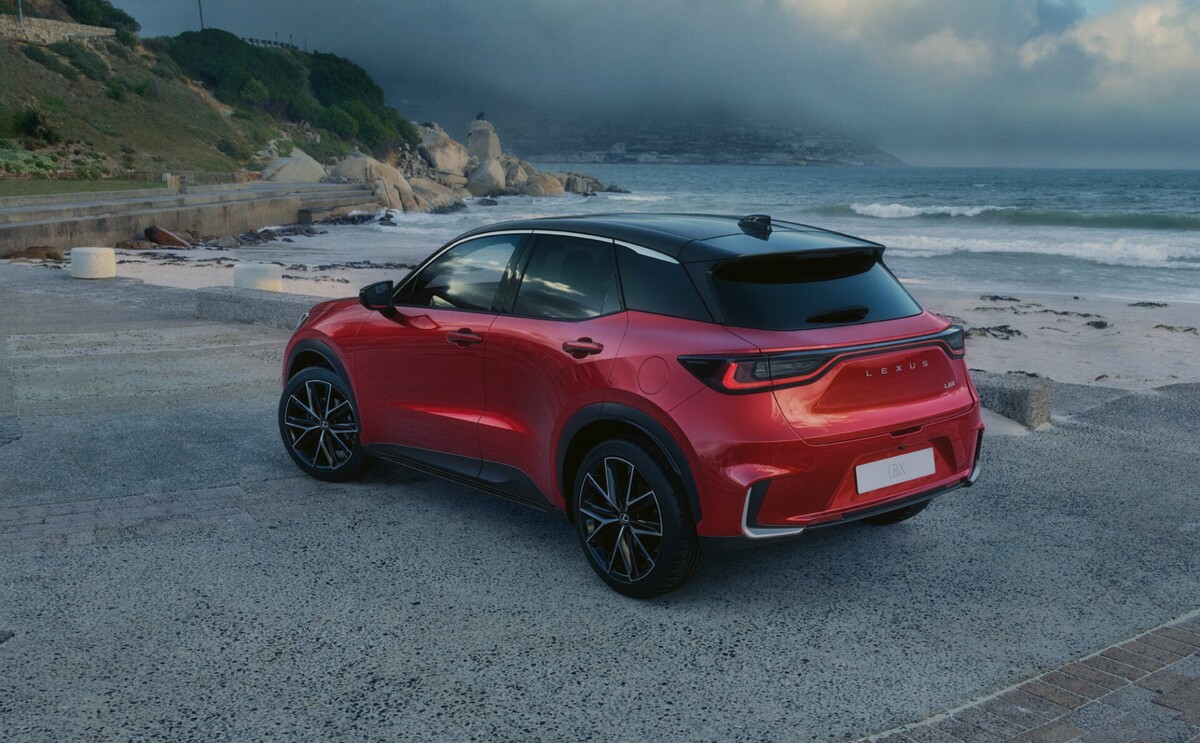 Lexus LBX parked by the beach in red, indicating its adaptability and style in any setting. Lexus LBX parked by the beach in red, indicating its adaptability and style in any setting.