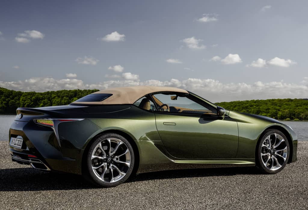 Lexus LC Cabrio aparcado mostrando su silueta lateral con naturaleza de fondo.