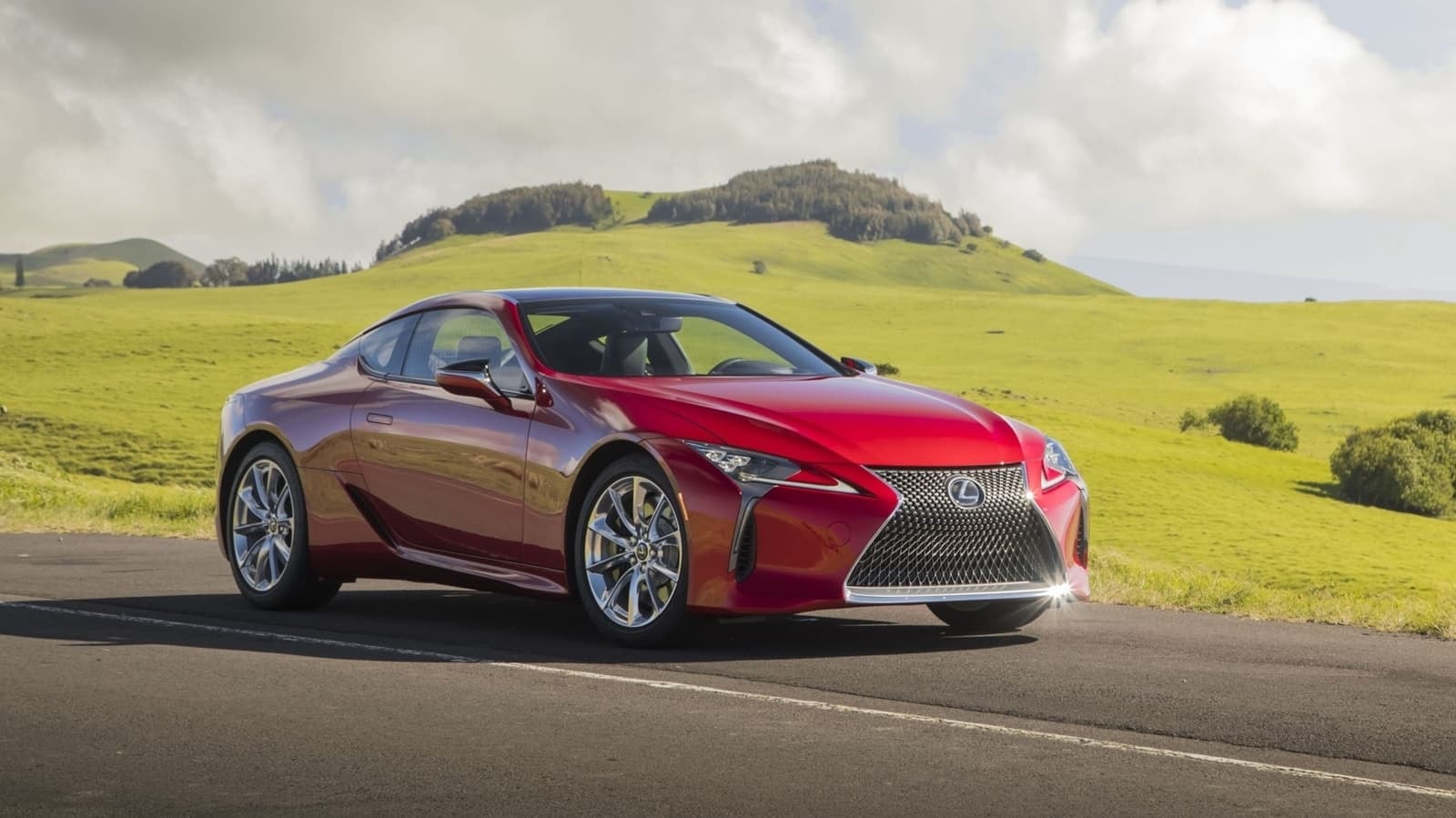 Perfil estilizado del Lexus LC híbrido en carretera, destacando líneas y llantas.