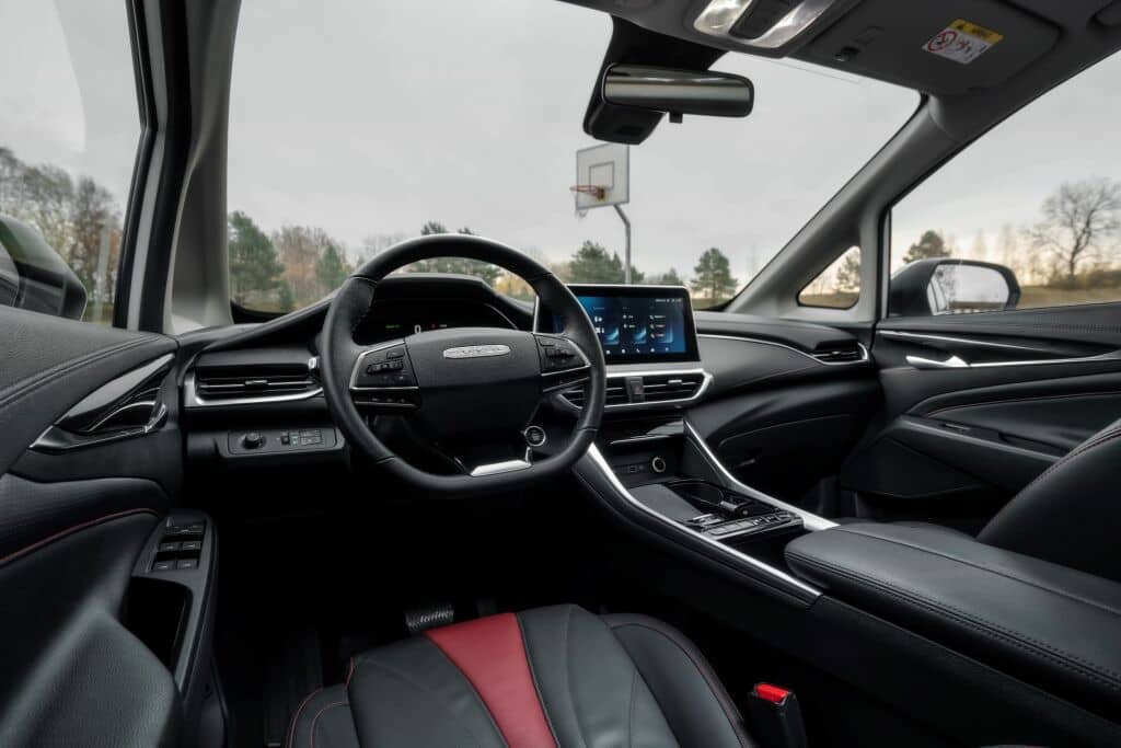 Cabina del conductor del Maxus Euniq 5 con enfoque en el volante y pantalla central.