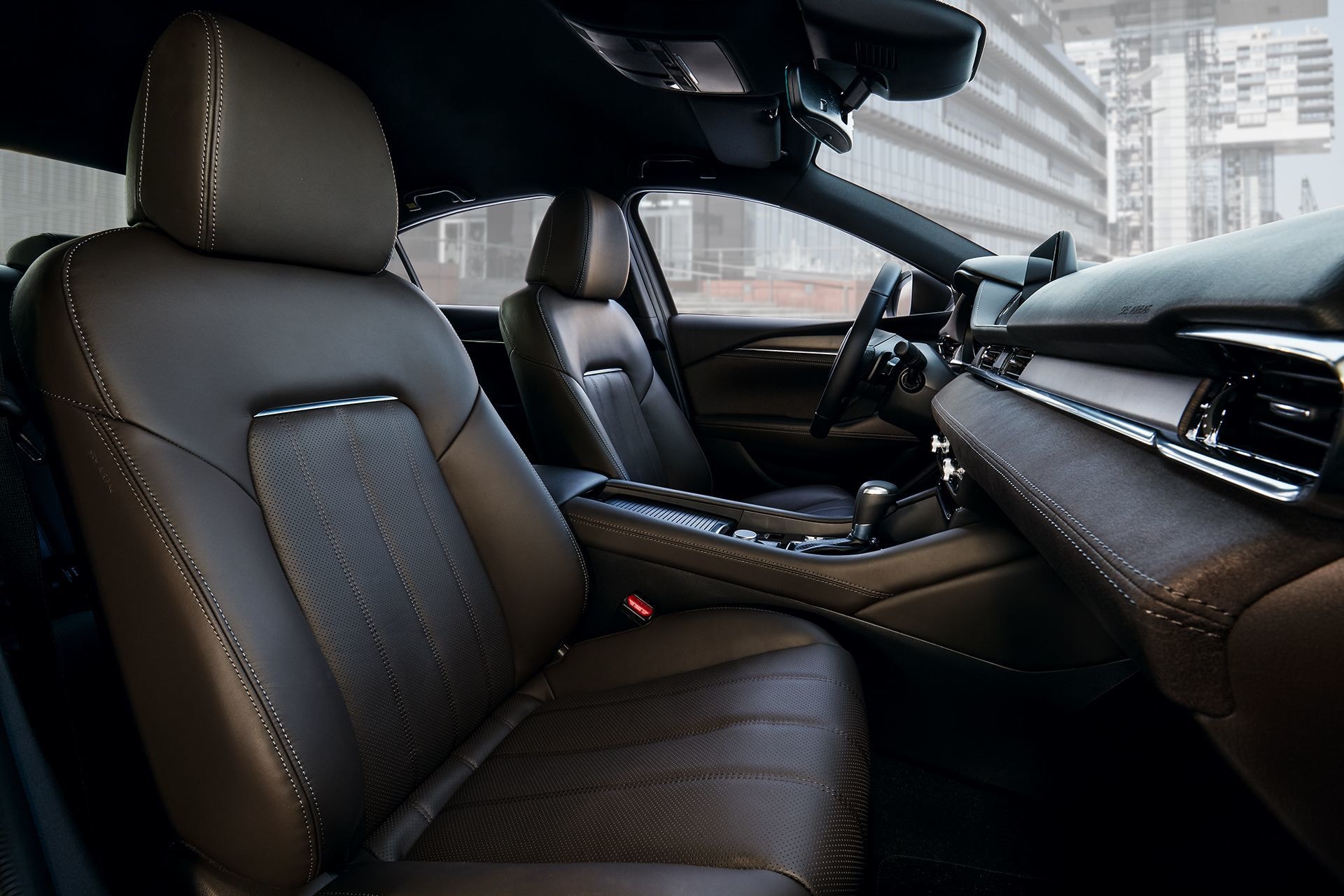 Vista delantera de la cabina con asientos de cuero marrón.