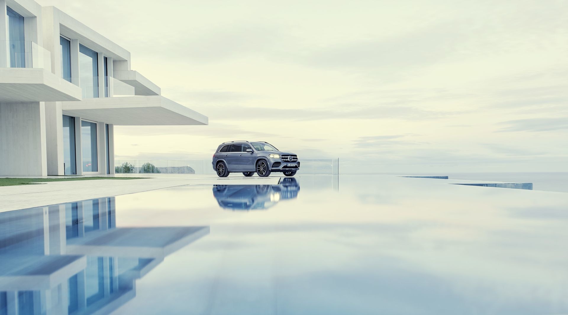 Mercedes GLS reflejado, armonizando con la arquitectura contemporánea.