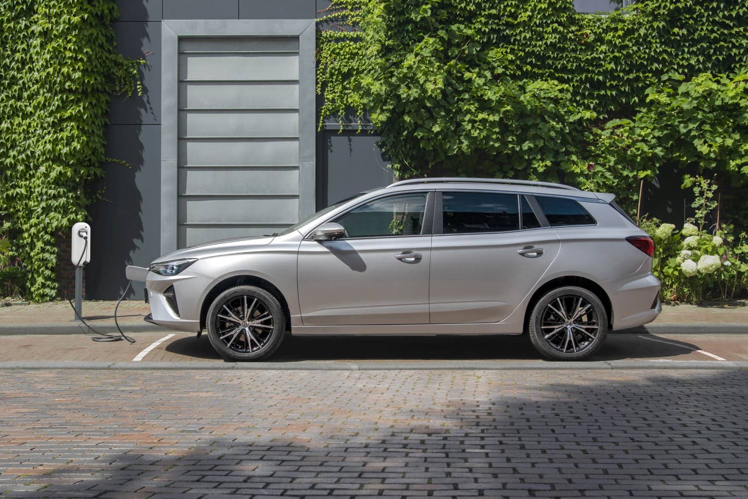 MG 5 eléctrico estacionado y cargando en una estación de carga urbana.