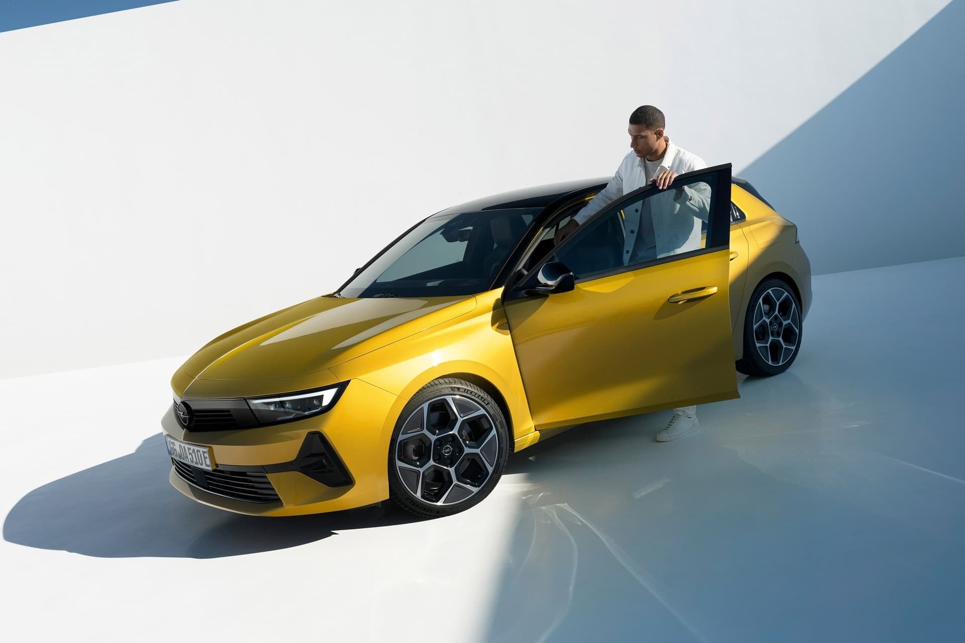 Opel Astra cabrio con su conductor, enfocado en la parte frontal y lateral.