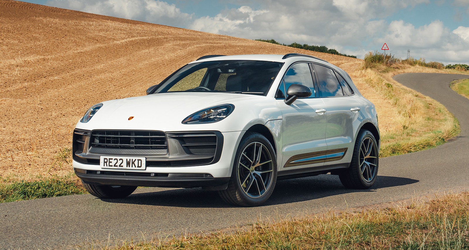 Vista lateral del Porsche Macan destacando su perfil y llantas deportivas.