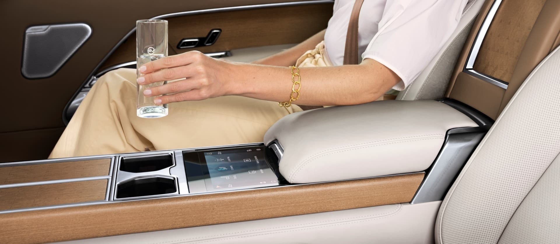 Detalle de la consola y acabados premium, con bandeja desplegable para objetos.