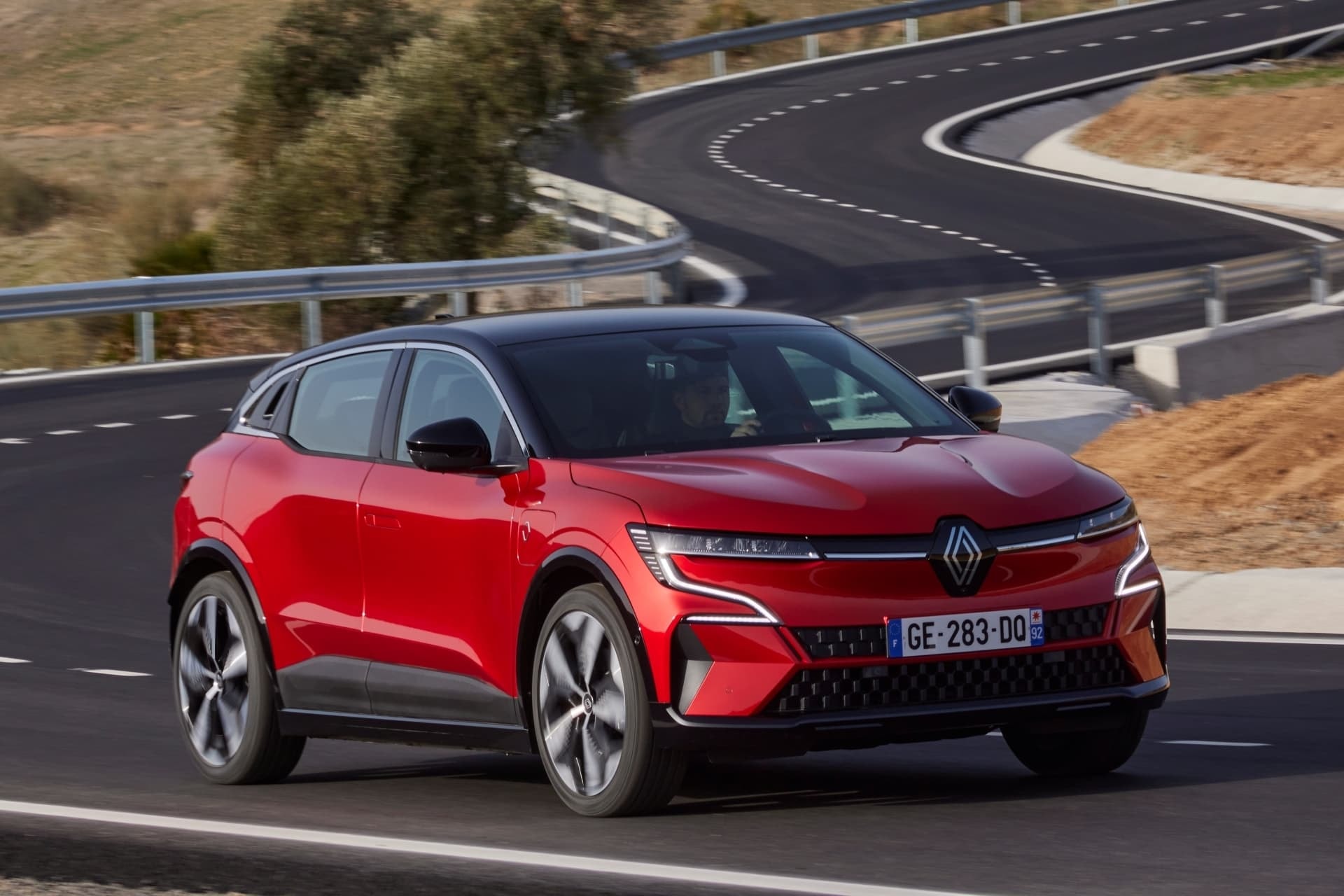 Vista lateral del Renault Mégane E-Tech eléctrico en curva, enfatizando su diseño.