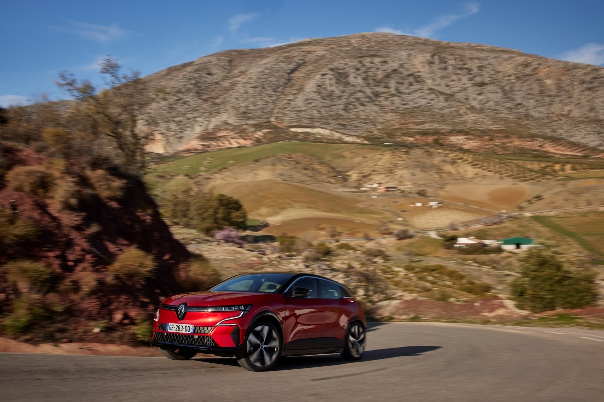 Trasera del Mégane E-Tech eléctrico tomando una curva, destacando su diseño.