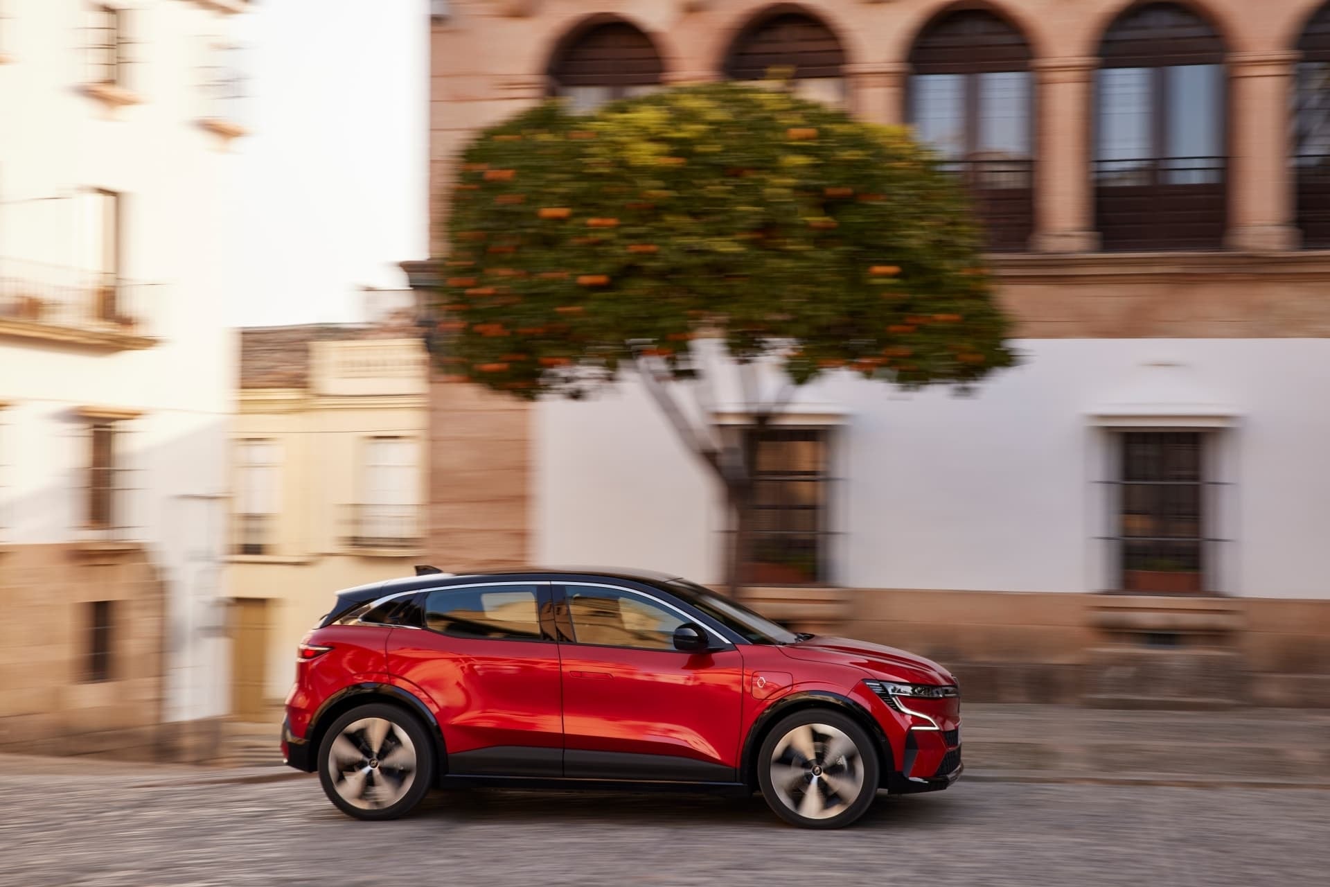 Vista en acción del Mégane E-Tech por calles urbanas, destacando su agilidad.