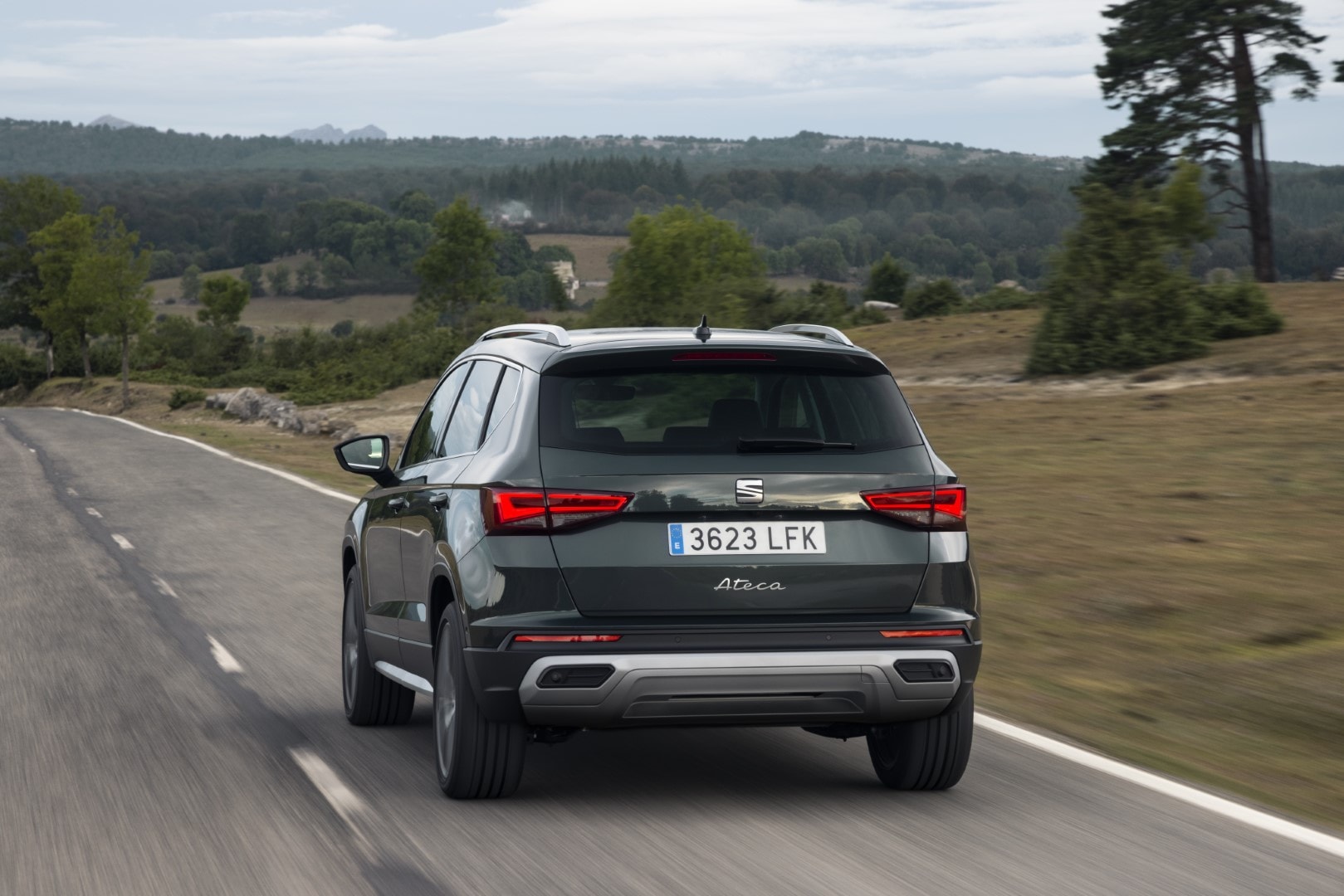 Vista trasera del Ateca en carretera que muestra su diseño y escape.