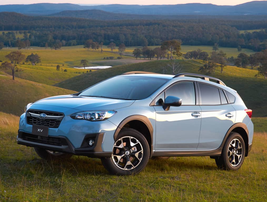 Perfil del Subaru XV en color azul, destacando su silueta en paisaje campestre.