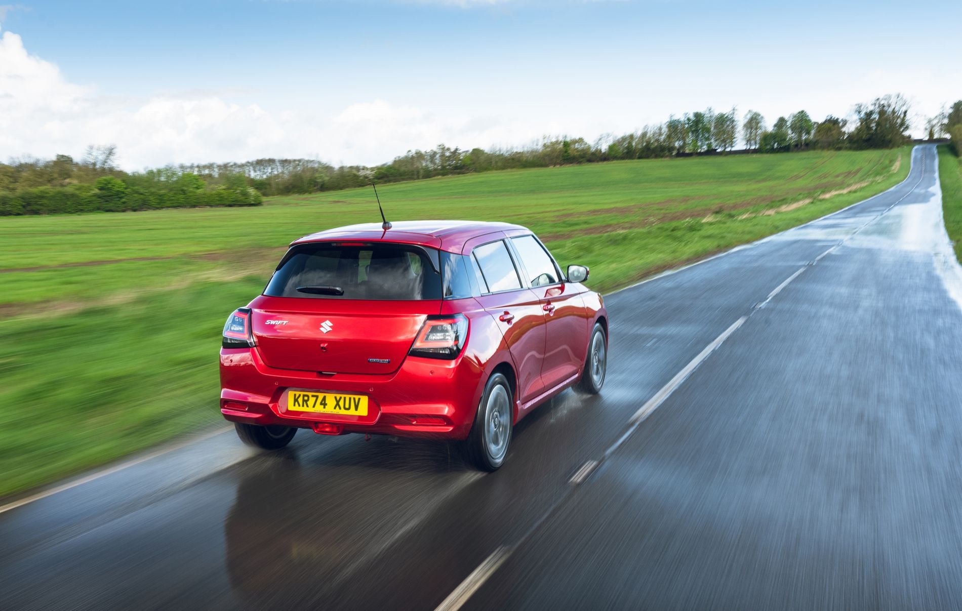 Suzuki Swift en movimiento, capturando su aspecto deportivo en carretera.