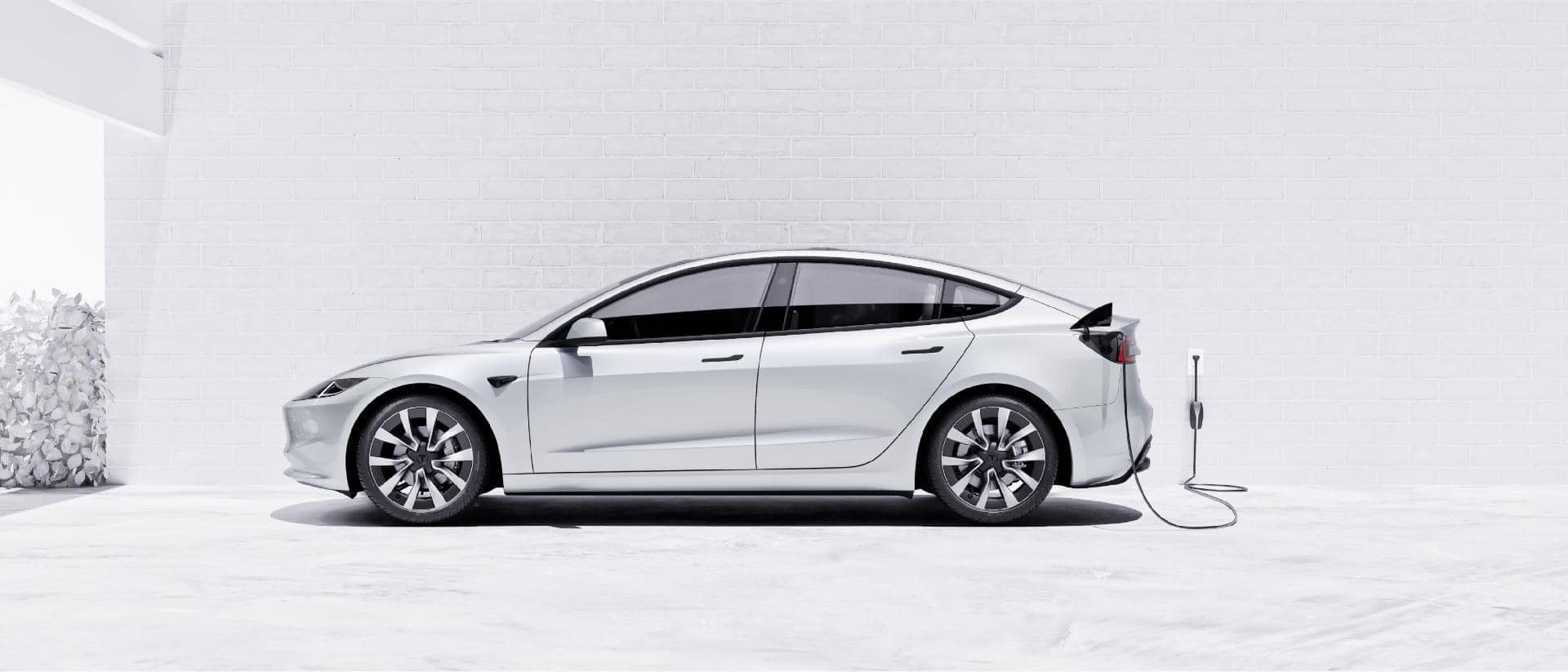 Profile view of Tesla Model 3 charging, emphasizing its sleek design and electric power.