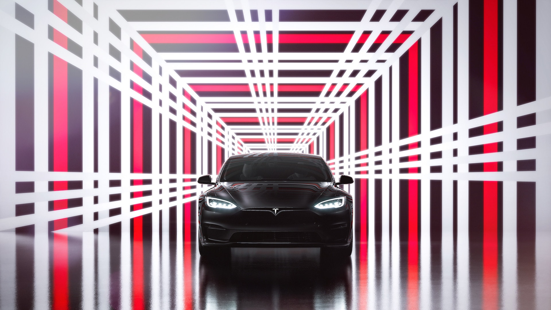 Frente del Tesla Model S negro en un túnel de luces, resaltando su diseño futurista.