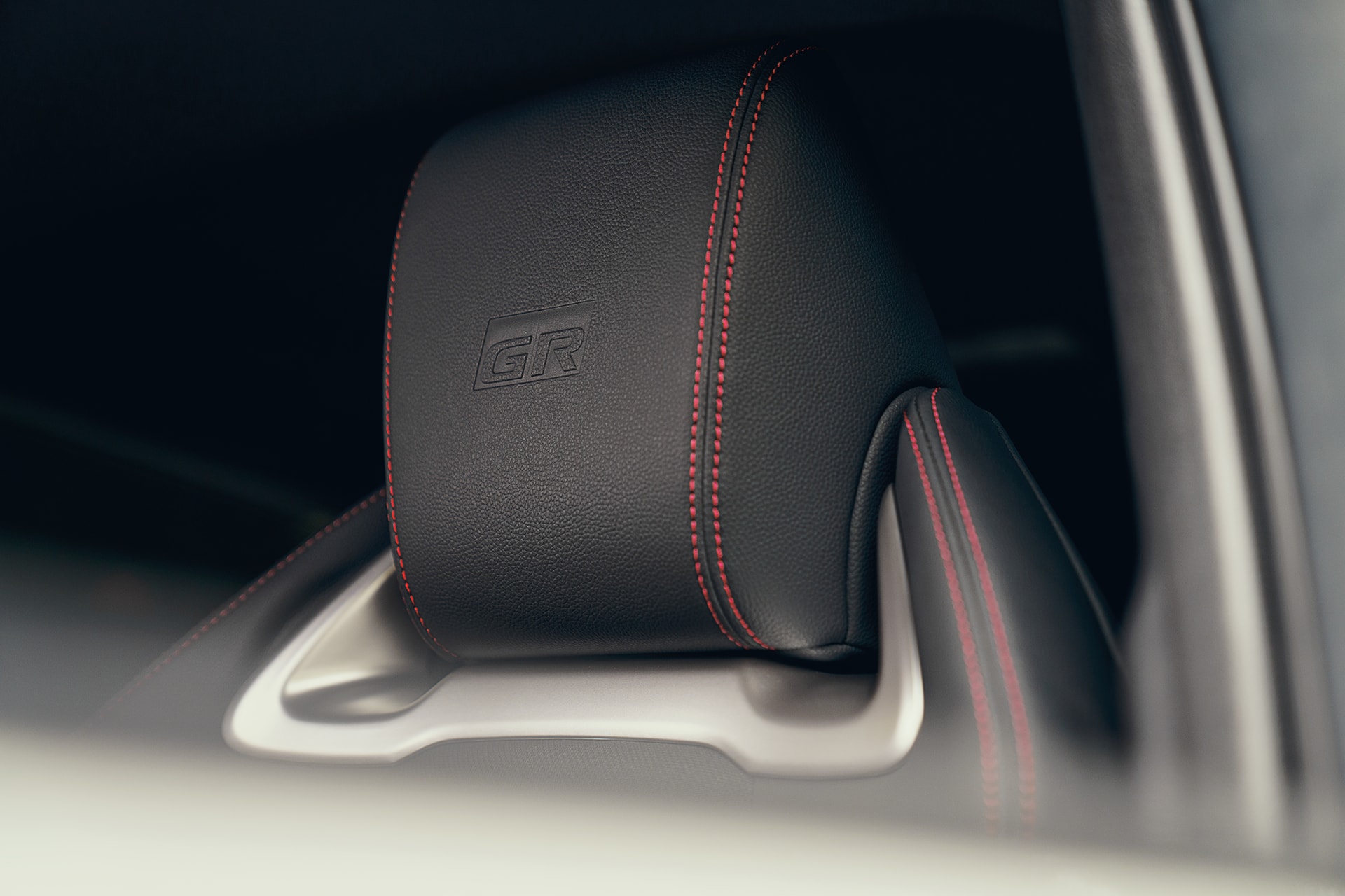 Detalle del reposacabezas con costuras rojas del Corolla Touring Sports, con sello GR.