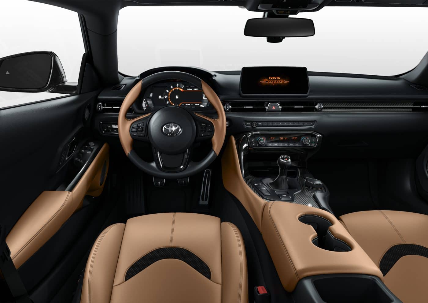 Vista del habitáculo del Toyota GR Supra con asientos en cuero marrón y detalles en negro.