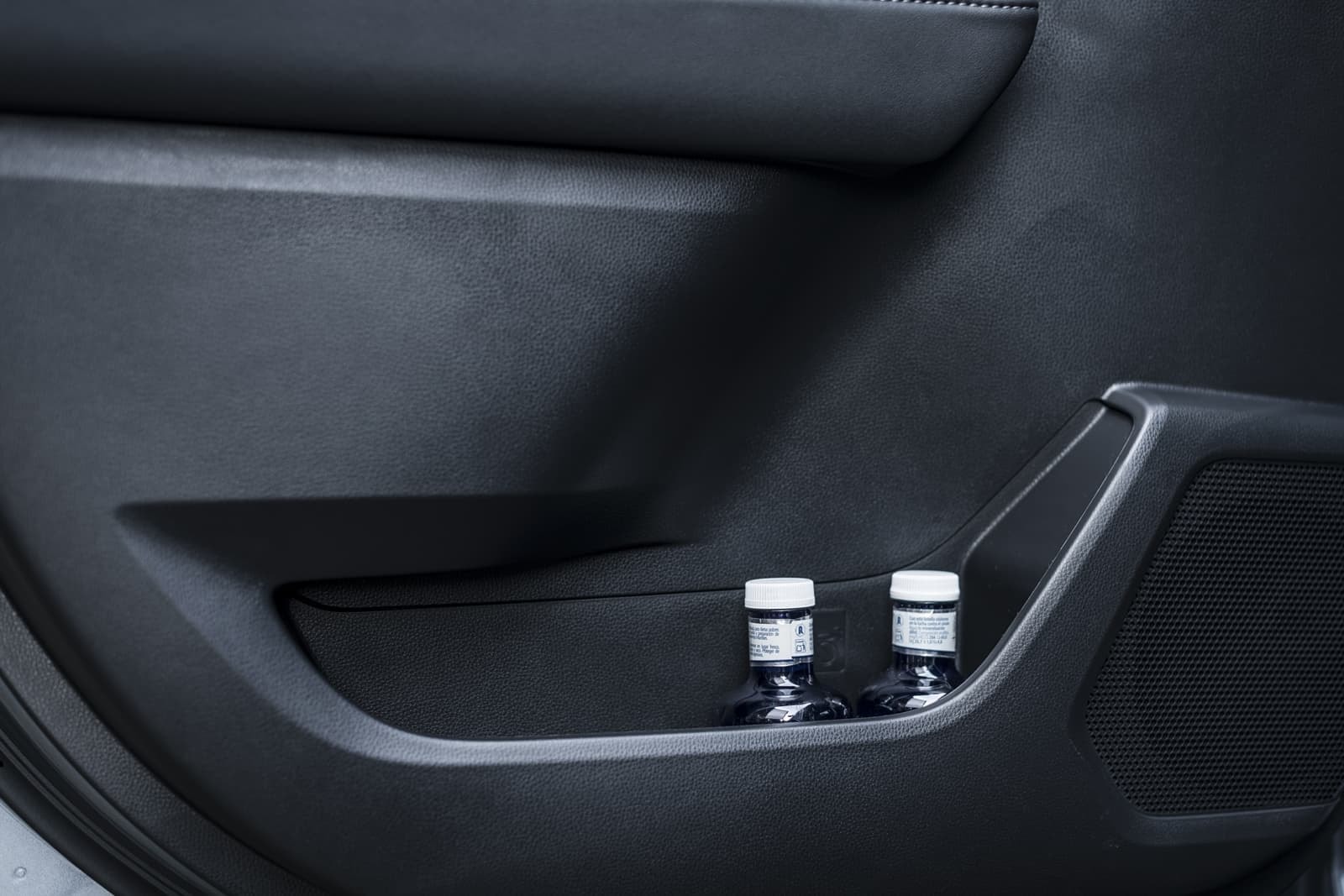 Botellero trasero en puerta, acabado minimalista y funcional.