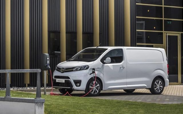 Toma lateral aérea de la furgoneta eléctrica Toyota ProAce en estación de carga.