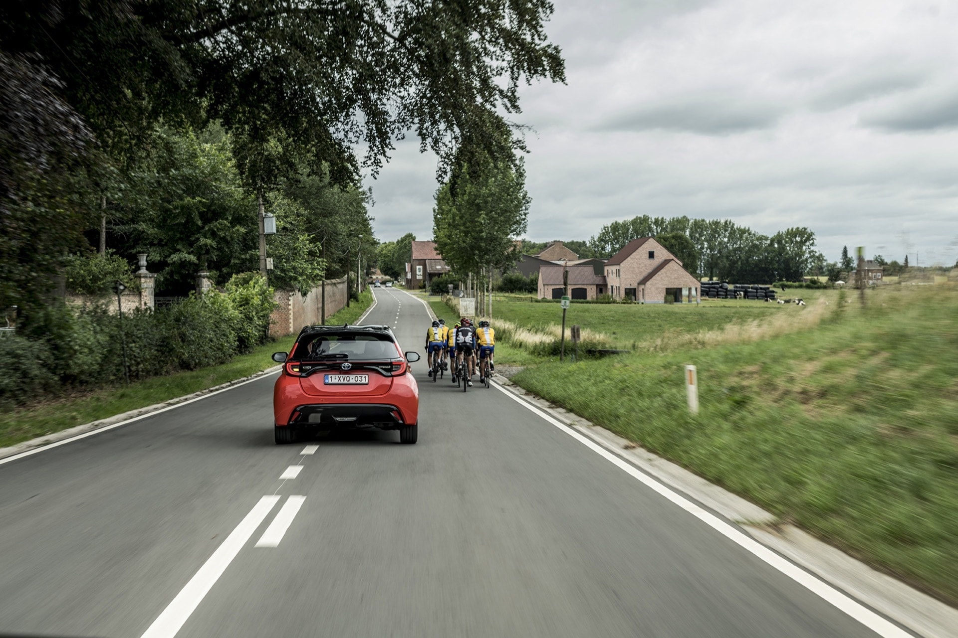 Vista dinámica del Toyota Yaris en carretera, resaltando su diseño posterior y lateral.