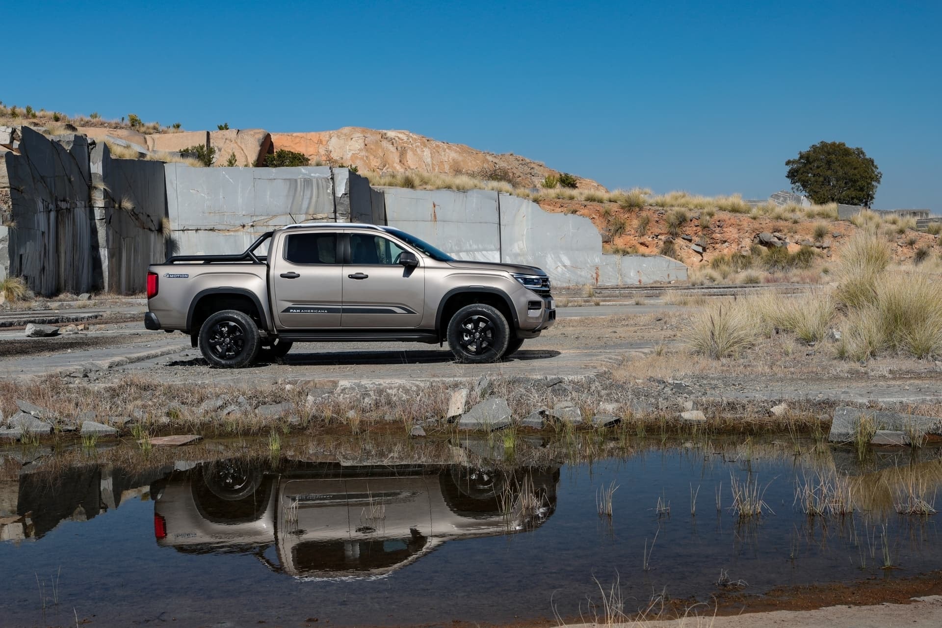 The Volkswagen Amarok parked on a rocky landscape, showcasing its rugged design.
