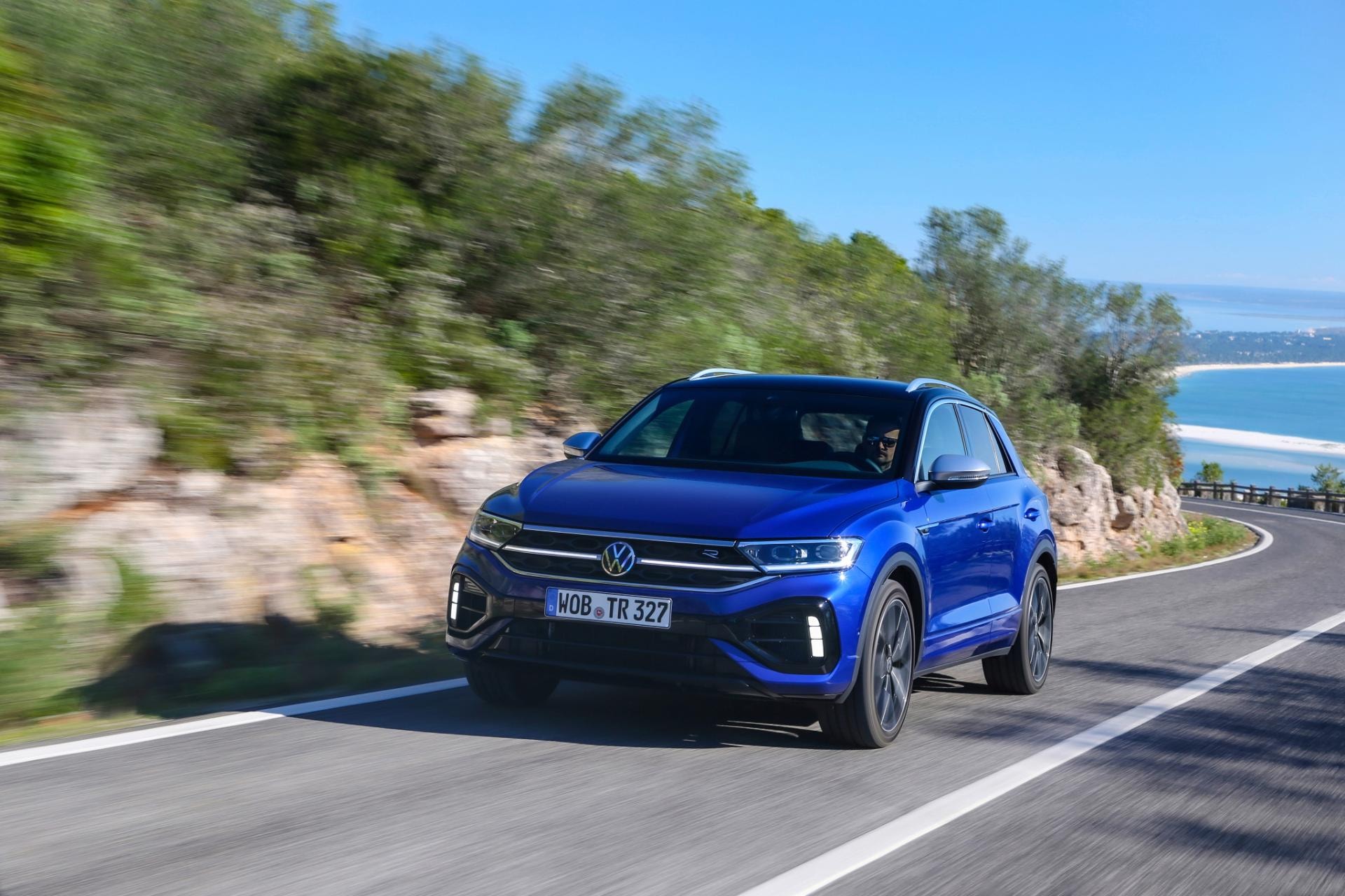 Perspectiva dinámica del T-Roc R en carretera, resaltando su línea lateral.