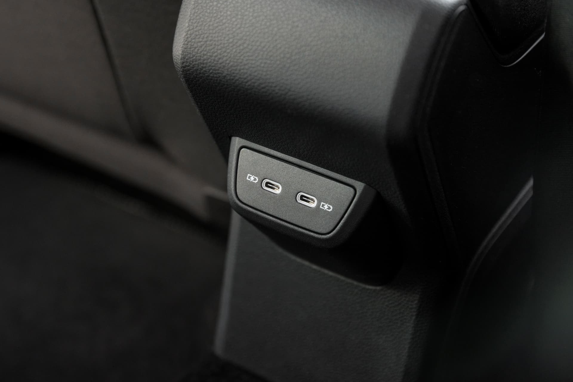 Puertos de carga USB para pasajeros traseros, detalle práctico y moderno.
